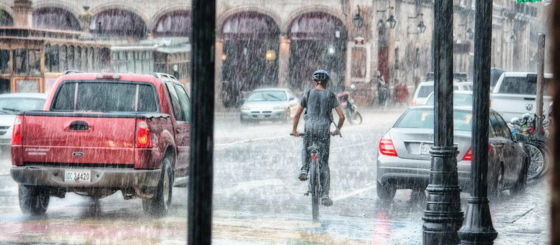 person-riding-a-bicycle-during-rainy-day-763398
